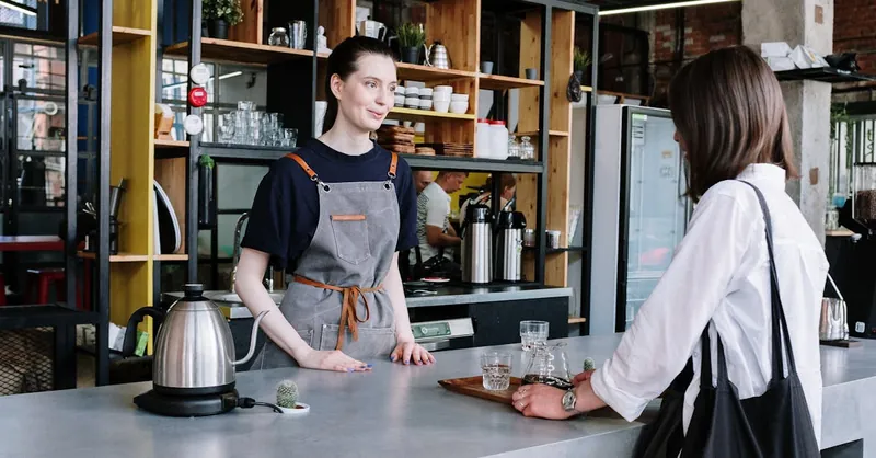 A barista and customer interaction at a contemporary café.