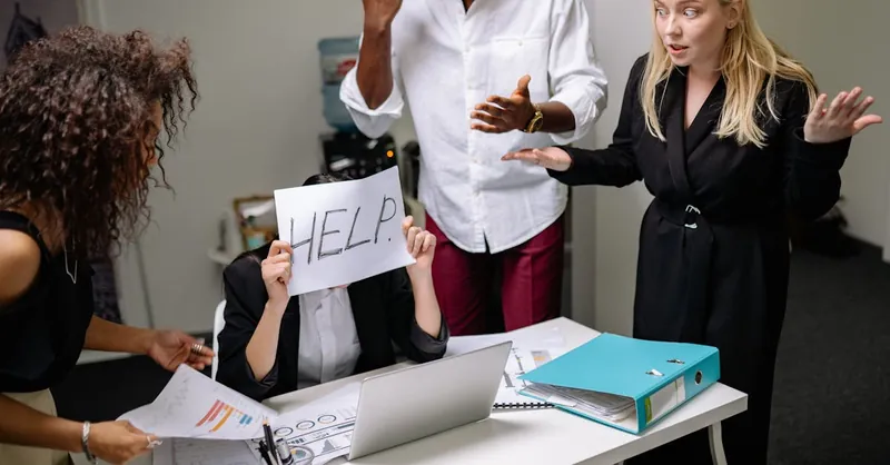A group of employees in heated discussion, one holding a 